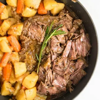 Easy One Pot Stovetop and Oven Pot Roast on White Marble Background.