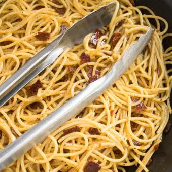 Easy One Pot Bacon Pasta With Tongs.