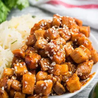 Easy One Pot Honey Sriracha Sesame Tofu on White Dish With Rice.