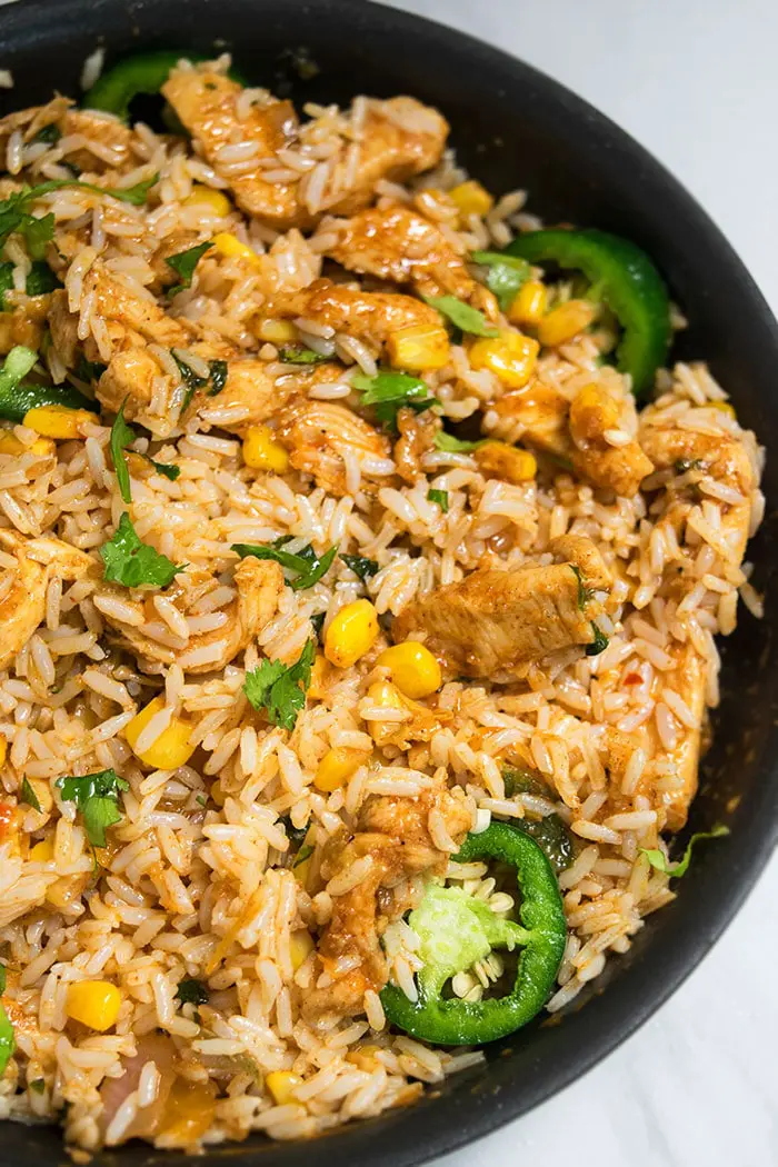 One Pot Chicken and Rice on Marble Background- Overhead Shot.