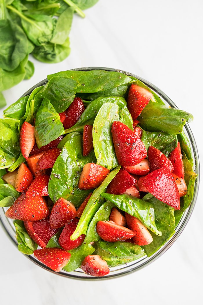 Easy Strawberry Spinach Salad With Poppy Seed Dressing on White Background.