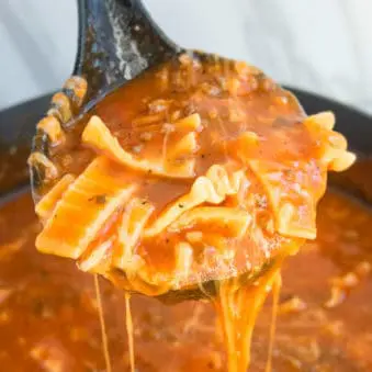 Easy One Pot Lasagna Soup in Big Ladle- Closeup Shot.