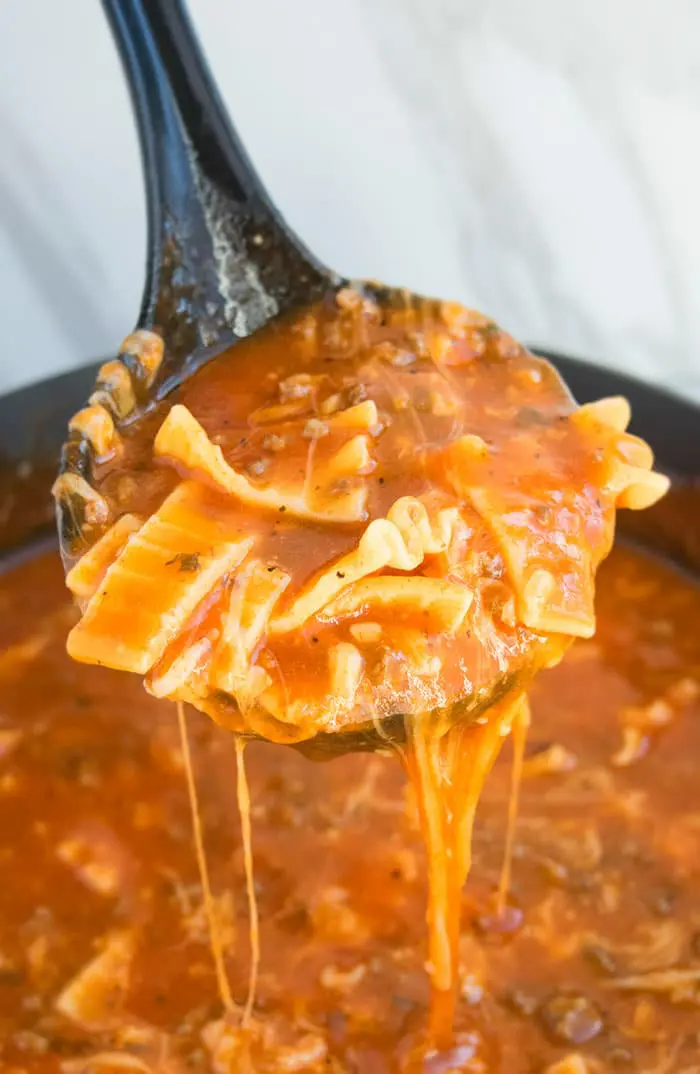 Easy One Pot Lasagna Soup in Big Ladle- Closeup Shot.