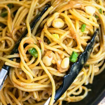 Easy One Pot Thai Peanut Noodles With Tongs.