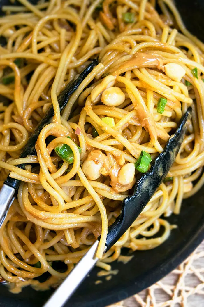 Easy One Pot Thai Peanut Noodles With Tongs.