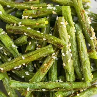 Easy Crispy One Pan Oven Roasted Green Beans on White Dish.