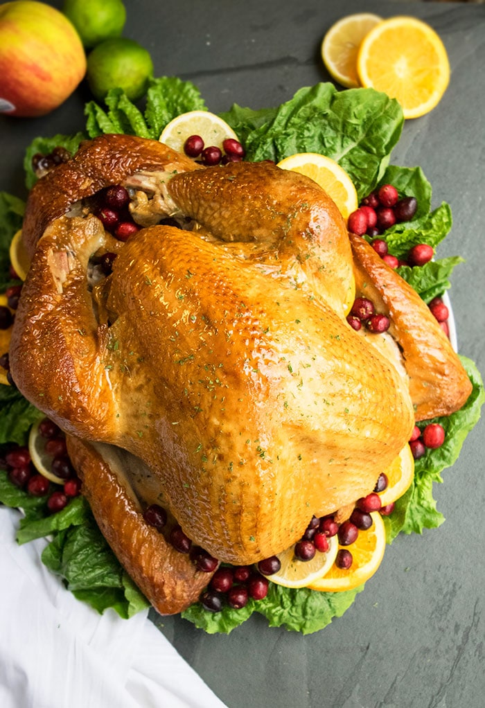 Best Easy One Pan Thanksgiving Turkey in White Dish With Greens and Cranberries.