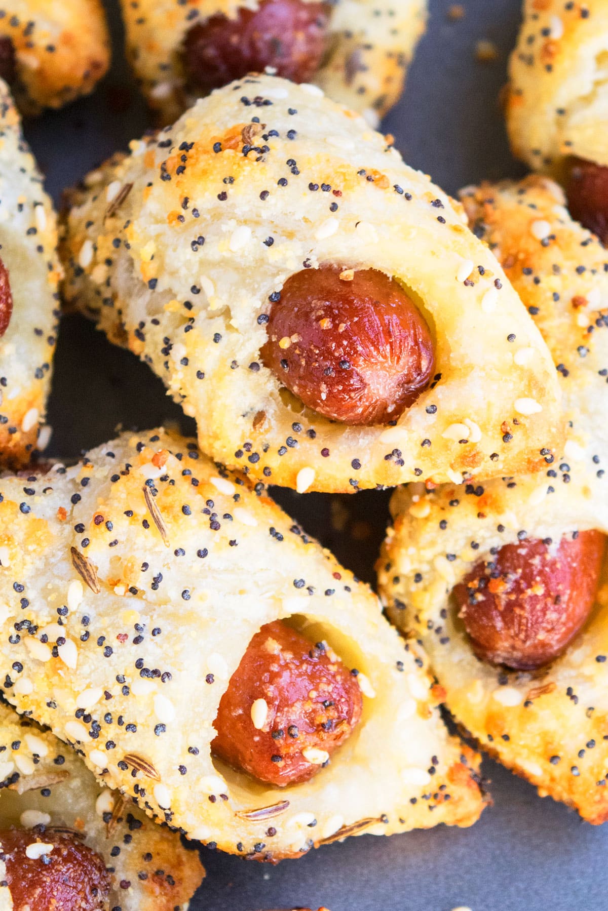 Stack of mini crescent dogs on baking tray.