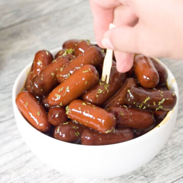 Toothpick being used to pick up a cocktail weenie. 