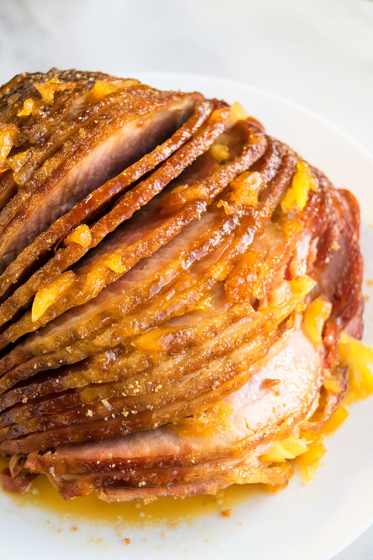 Sliced spiral ham on white dish- Closeup shot.