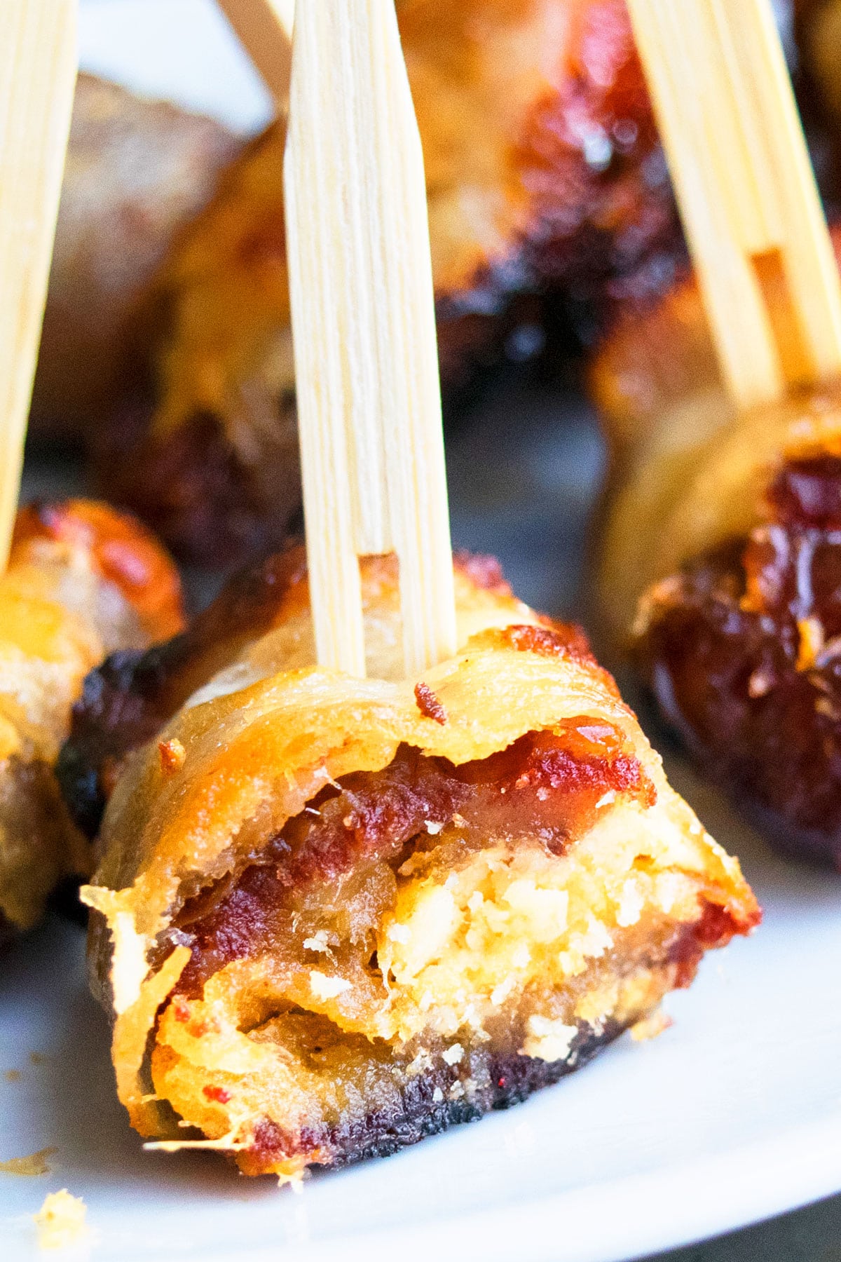 Closeup shot of partially eaten stuffed dates with goat cheese.