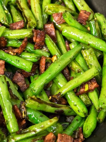 Best easy one pot green beans with bacon, onions and seasoning in black nonstick pot- Overhead shot.