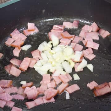 Bacon, garlic and onions added to melted butter and oil. 
