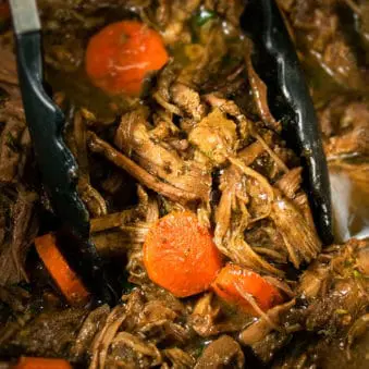 Easy Instant Pot Pot Roast With Black Tongs.