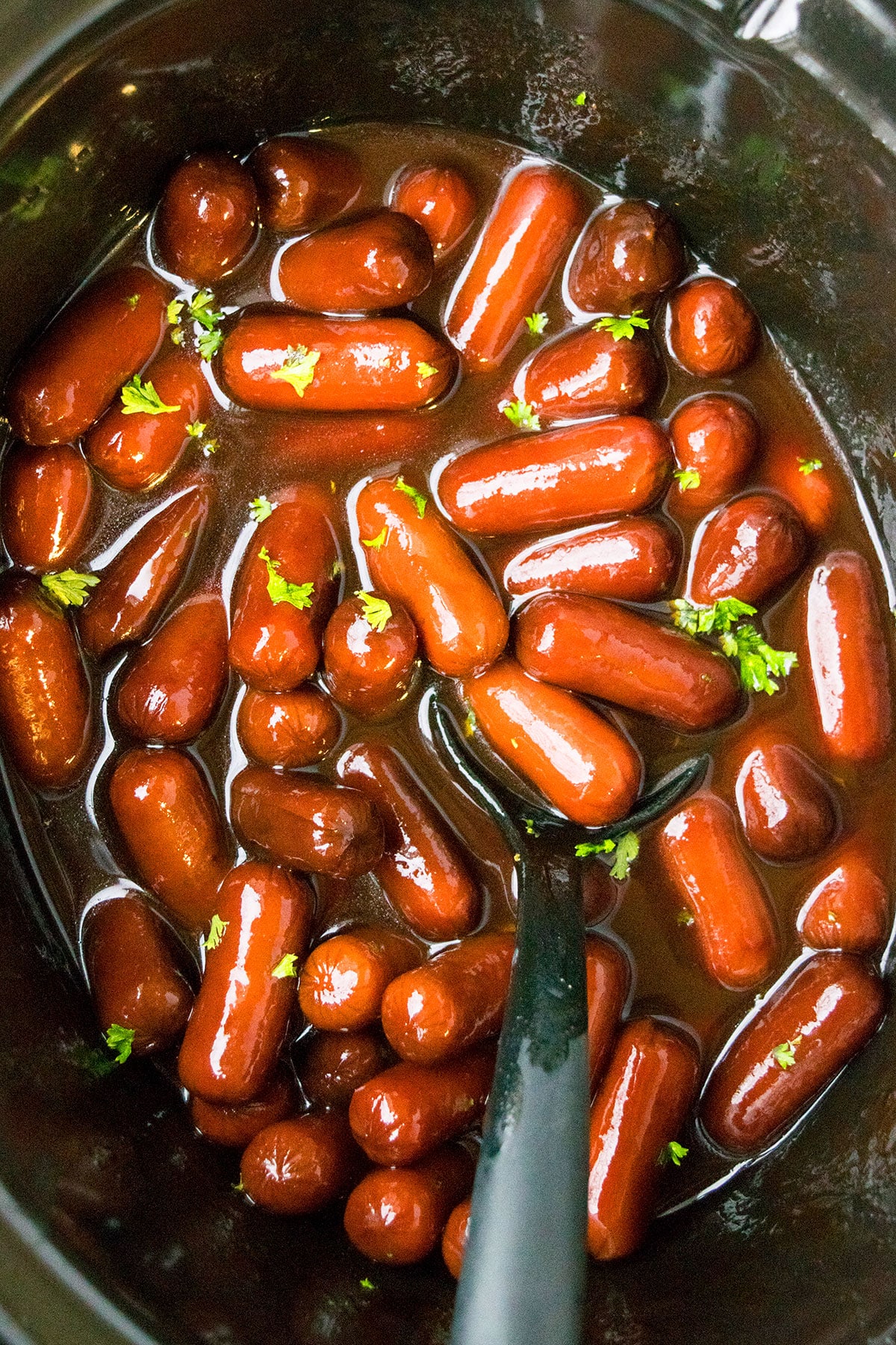 Crockpot Little Smokies With Parsley Garnish- Overhead Shot. 