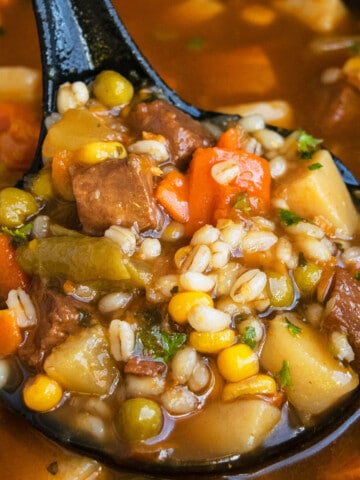 Ladle Full of Best Easy One Pot Beef Barley Soup With Vegetables.