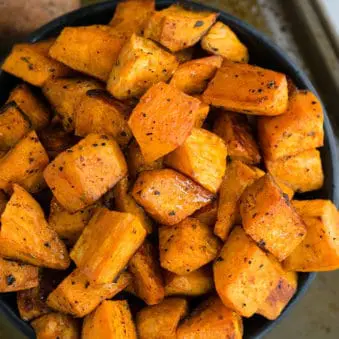 Easy Crispy Oven Roasted Sweet Potatoes in Black Bowl.