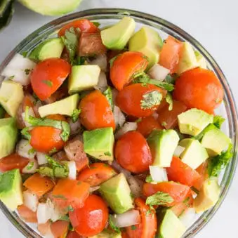 Easy Tomato Avocado Salad in Glass Bowl.