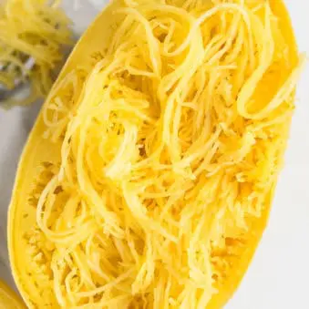 Cooked Whole Spaghetti Squash in Instant Pot or Pressure Cooker Placed on Marble White Background.