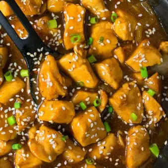 Easy Chinese Honey Sesame Chicken in Black Nonstick Pot.