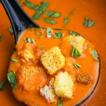 Ladle Full of Easy Roasted Red Pepper Soup- Closeup Shot.