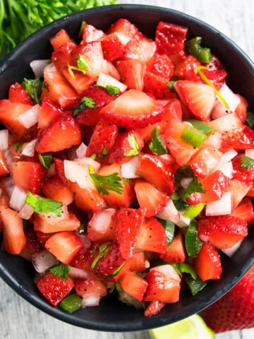 Best easy fresh strawberry salsa in black bowl- Overhead shot.