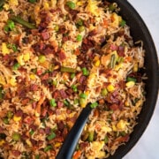 Best easy one pot bacon fried rice in nonstick pan with black spoon- Overhead shot.