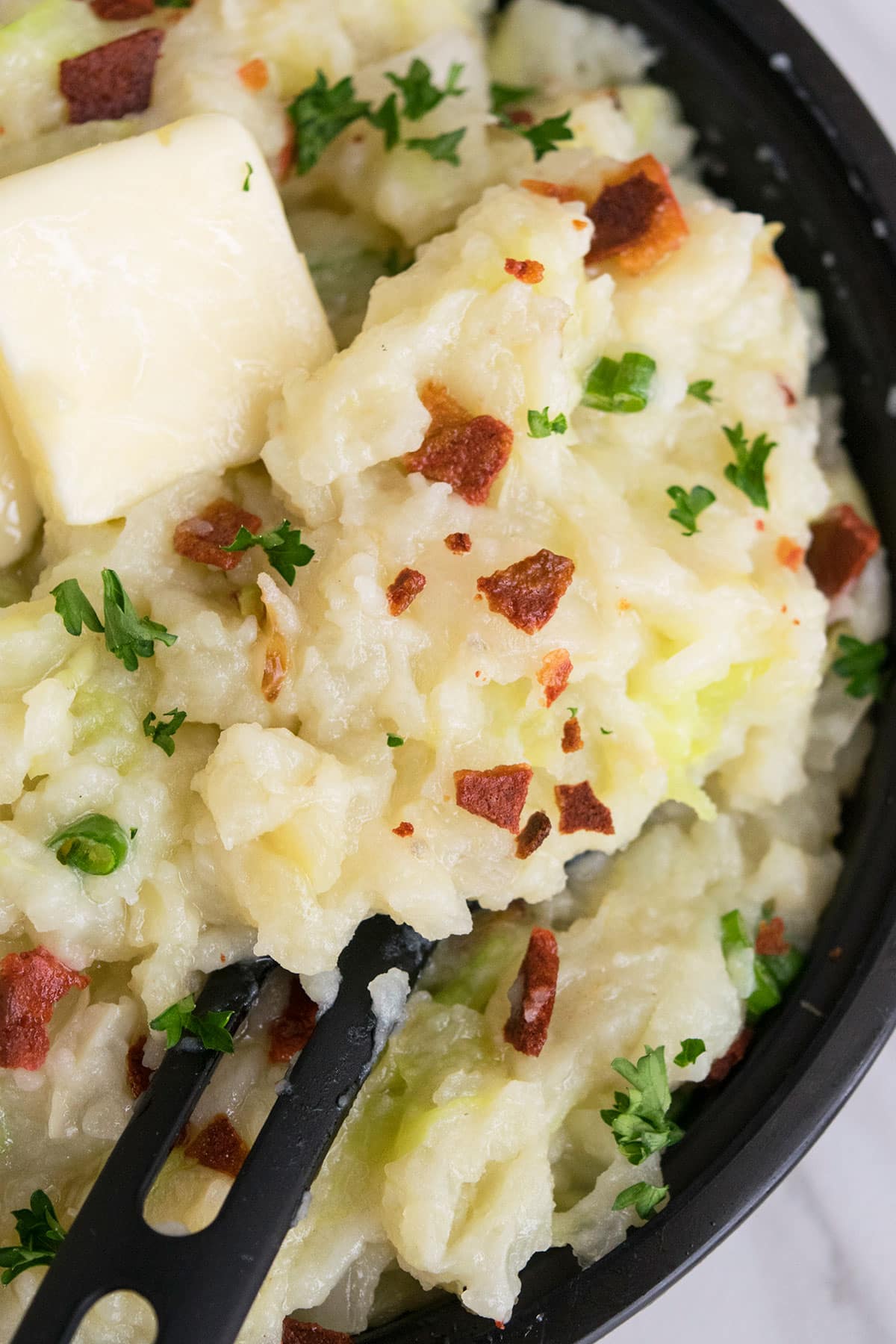 Spoonful of Irish mashed potatoes with cabbage and bacon- Closeup shot. 