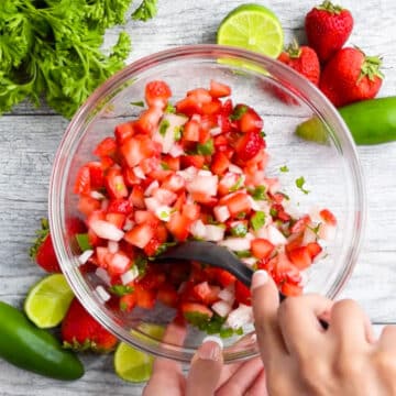 Ingredients being mixed together with black spoon.