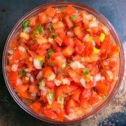 Best easy homemade Mexican pico de gallo salsa in glass bowl- Overhead shot.