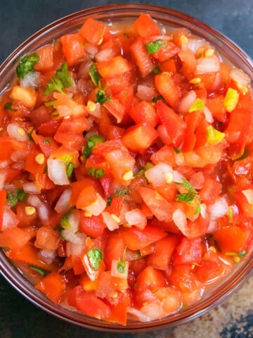 Best easy homemade Mexican pico de gallo salsa in glass bowl- Overhead shot.