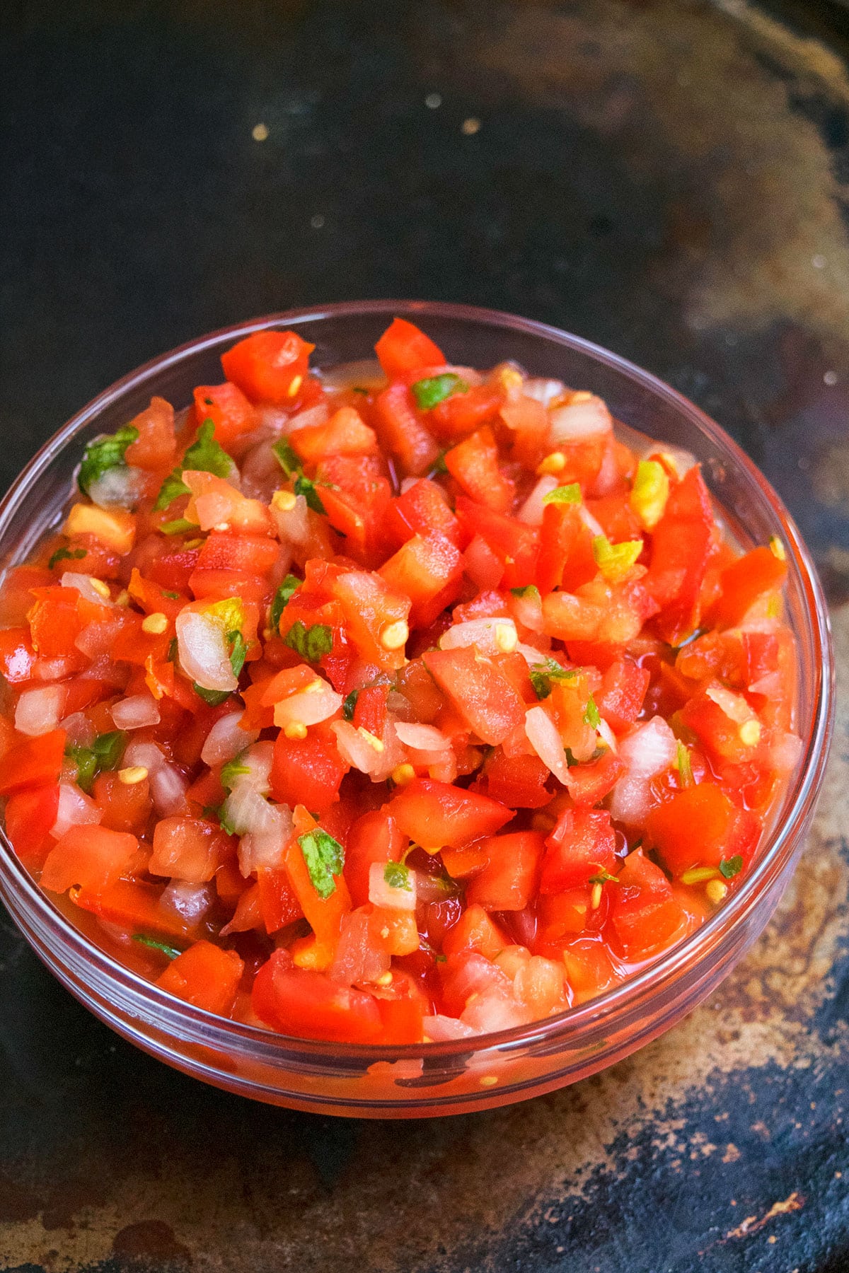 Tomato salsa in glass bowl. 