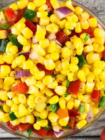 Best easy homemade corn salsa in glass bowl on rustic gray background.