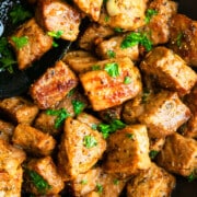 Best easy garlic butter steak bites in nonstick pan with black spoon.