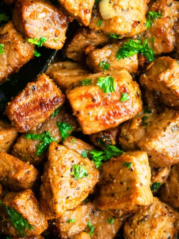 Best easy garlic butter steak bites in nonstick pan with black spoon.