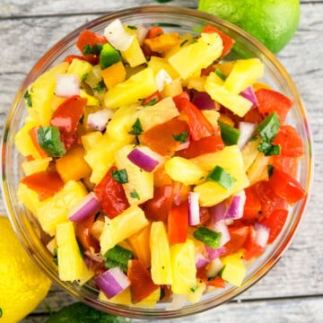 Best easy homemade pineapple salsa in glass bowl on rustic gray background.
