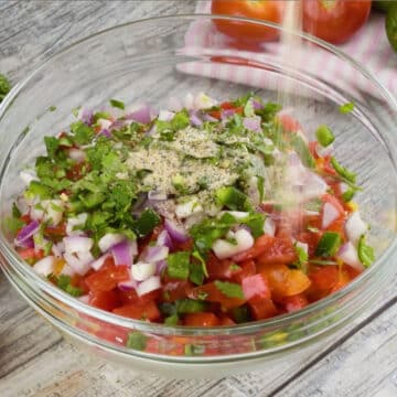 Ingredients being added to a large glass bowl. 