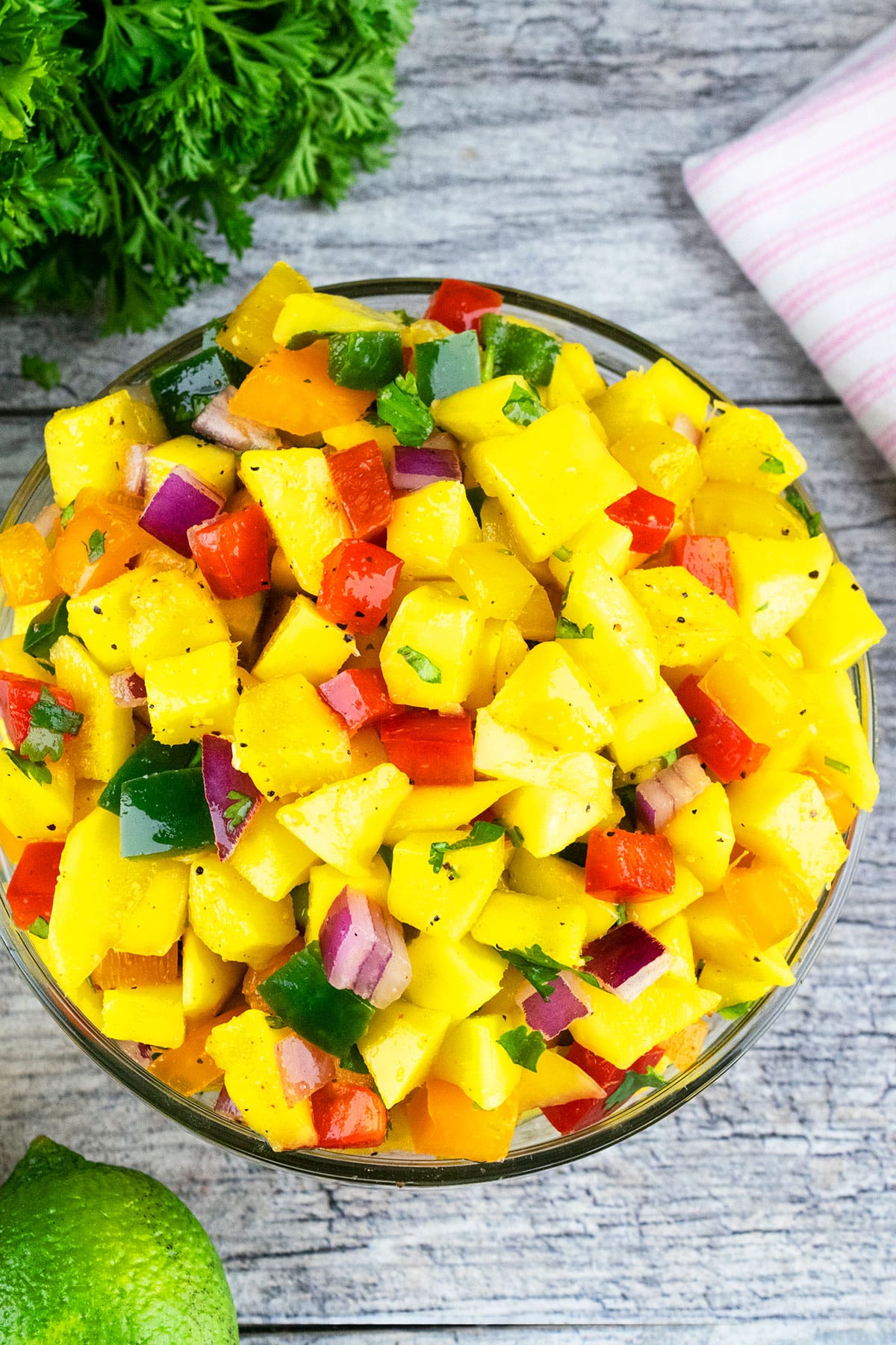Easy mango salsa in glass bowl- Overhead shot. 