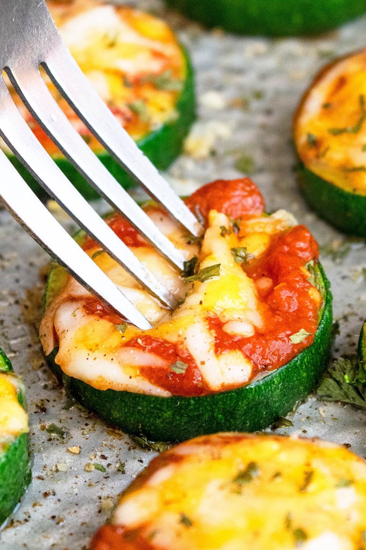Fork pushing into mini pizza. 