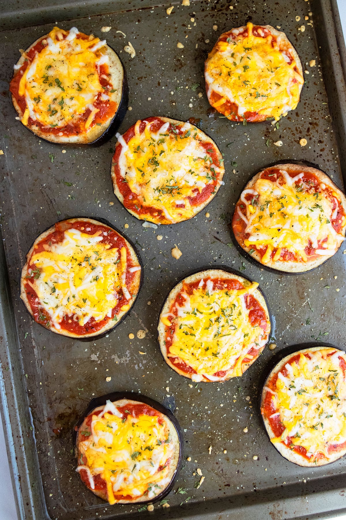 Baked mini pizzas on tray.