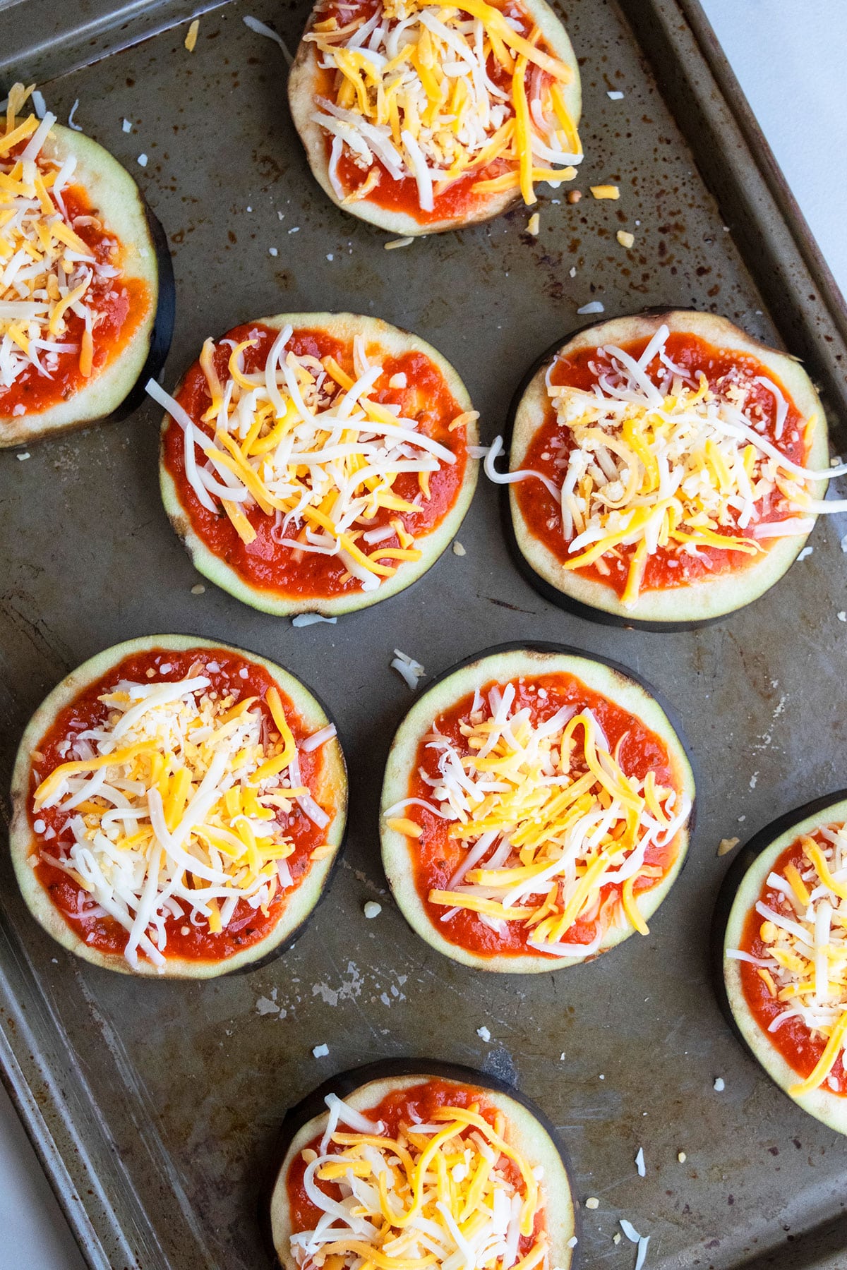 Unbaked low carb pizzas on baking tray.