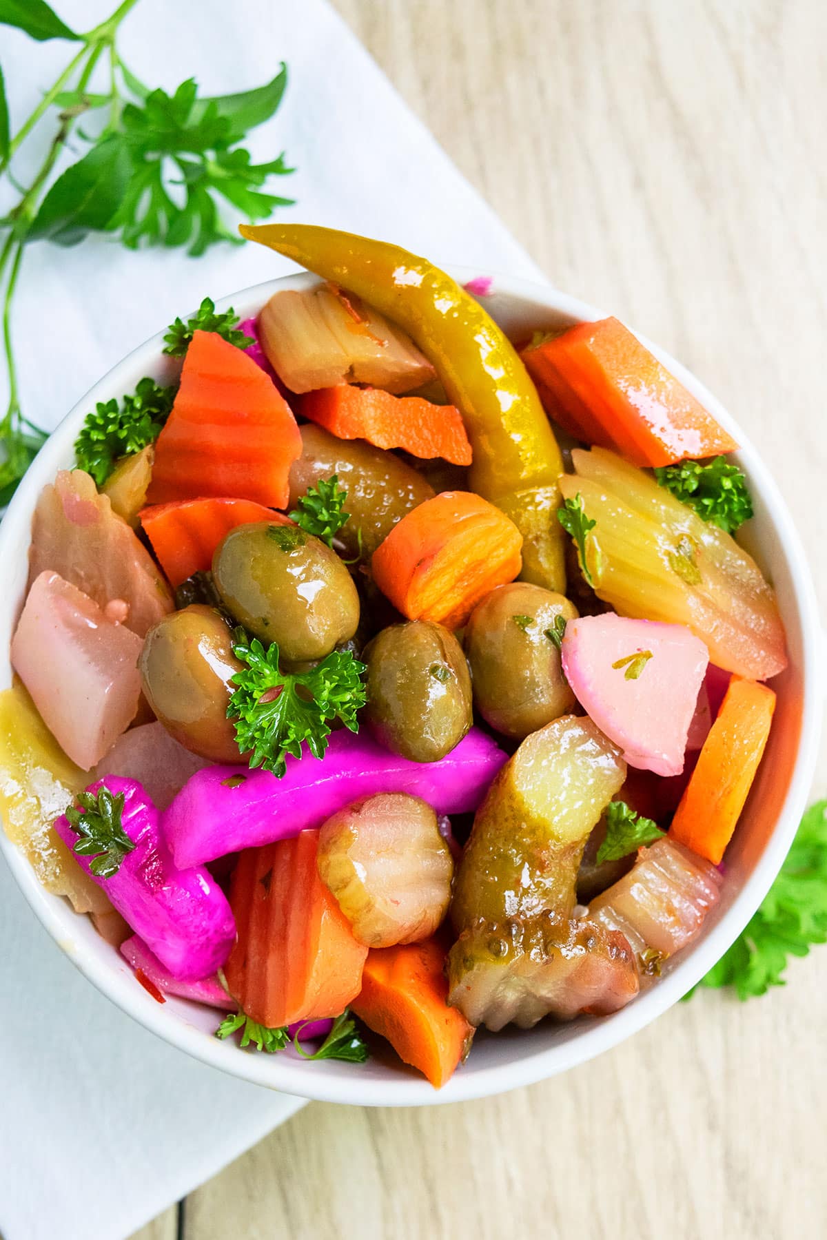 Quick pickled vegetables in white bowl- Overhead shot. 