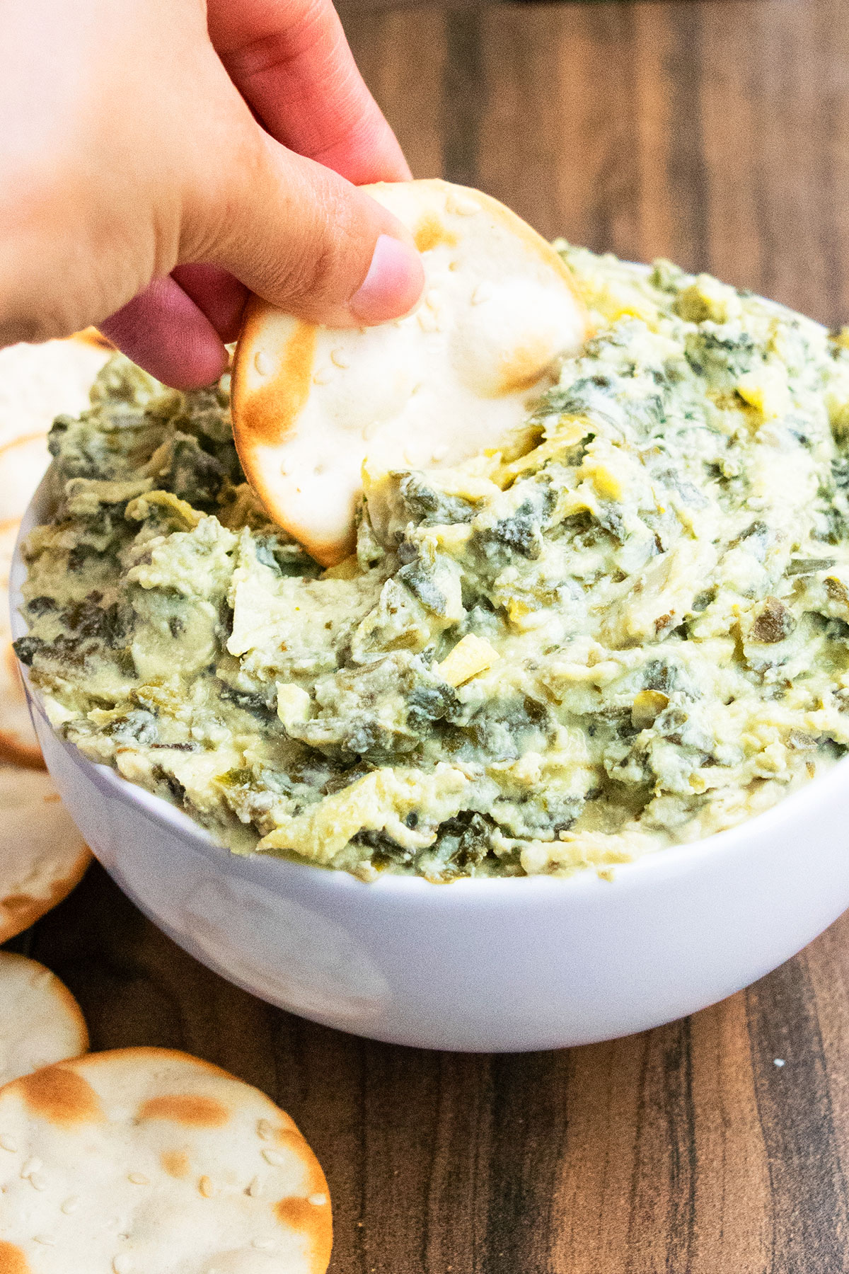 Cracker being dunked in hot dip. 