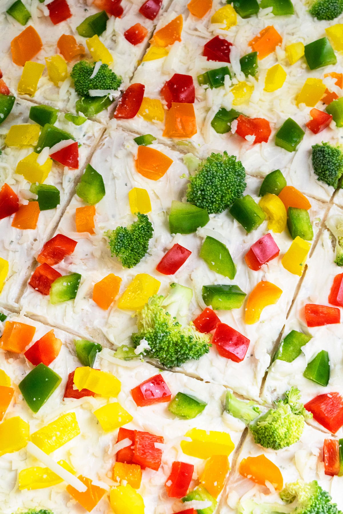Slices of homemade pizza with fresh vegetables and cheese. 