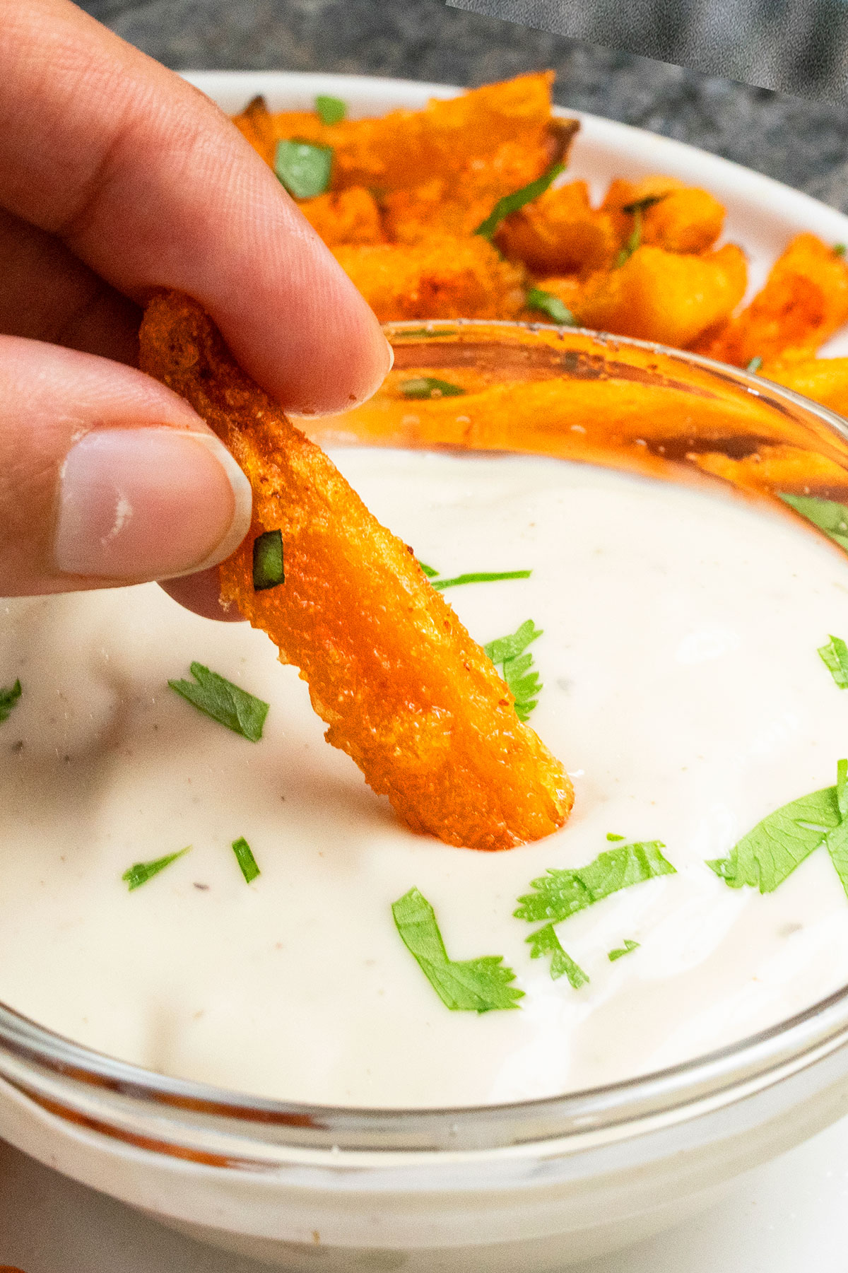 Fry being dipped in ranch sauce- Closeup shot. 