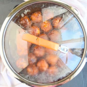 Lid covering pan while meatballs cook. 