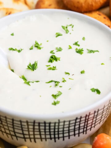 Best easy creamy homemade veggie dip in white bowl with a white spoon.