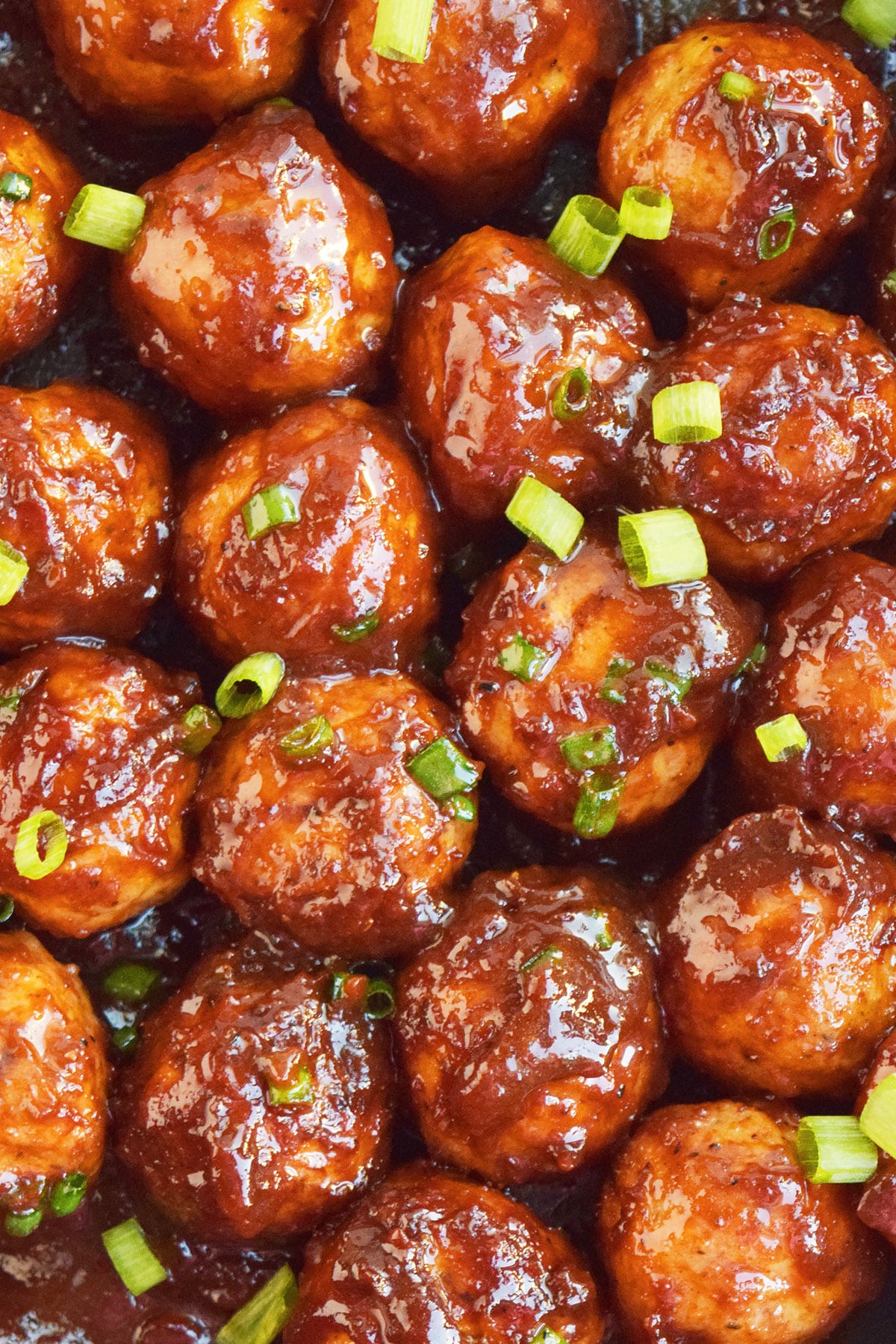 Closeup shot of coated sweet and spicy meatballs. 