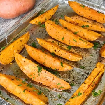 Baked wedges being garnished with fresh parsley.