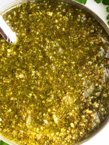 Easy homemade lender basil pesto sauce in bowl-Overhead shot.